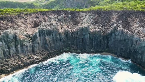Drone Flight Over Volcanic Basalt Cliffs and Ocean Cove in the Azores Stock Footage 336304463