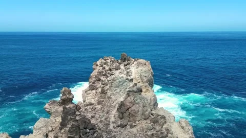 Drone Flight Over Volcanic Sea Stack Above Turquoise Atlantic Waters Stock Footage 336304506