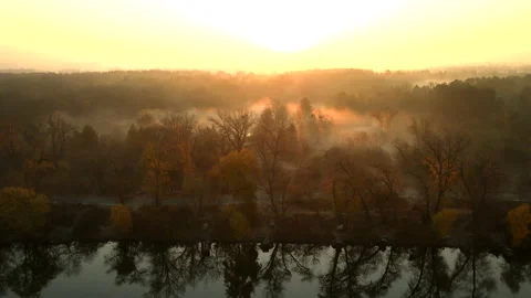 Drone flight over the water surface and the river bank on a foggy sunny morning Stock Footage 171908436