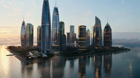 Drone Flight Over Water Toward Futuristic Cityscape at Golden Hour – 4K 库存影片 310996592