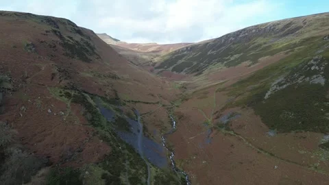Drone Flight Over Welsh Valley with Mountain River Flowing Through in 4K Video stock 330762100