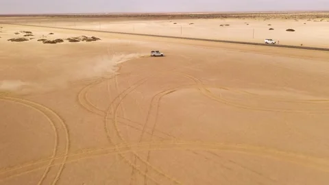 Drone flight over white SUV car dune drifting in desert Stock Footage 157555509