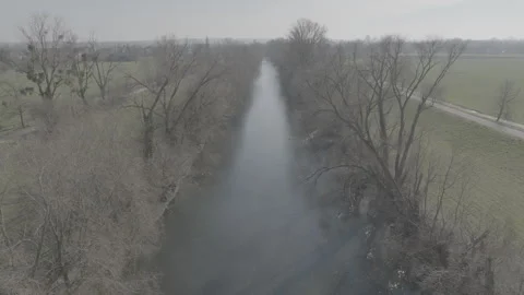 Drone Flight Over Winter Canal With Bare Trees Stock Footage 304016172
