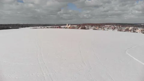 Drone flight over winter field, church view Stock Footage 228826309