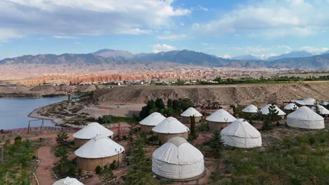Drone flight over yurt camp at Issyk-Kul Lake with mountain view, Kyrgyzstan. Stock Footage 315433483
