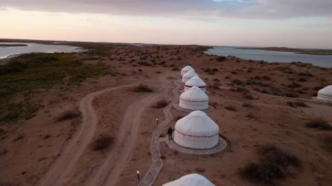 Drone flight over yurts on the shore of Lake Aydarkul Stock Footage 213187550