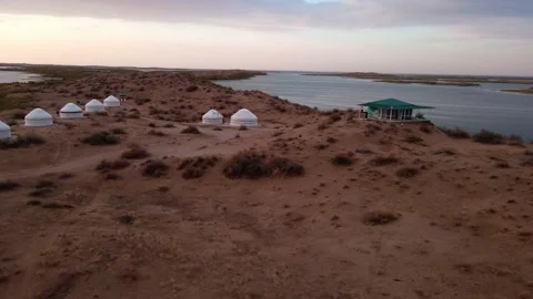 Drone flight over yurts on the shore of Lake Aydarkul Stock Footage 226715632