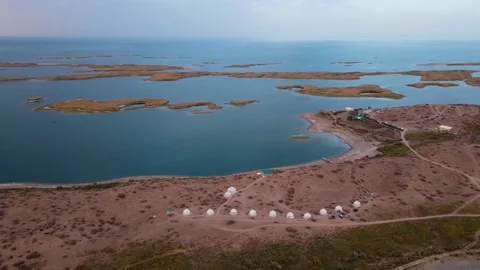 Drone flight over yurts on the shore of Lake Aydarkul Stock Footage 235883503