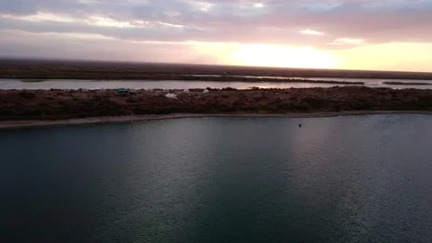 Drone flight over yurts on the shore of Lake Aydarkul Stock Footage 237735695