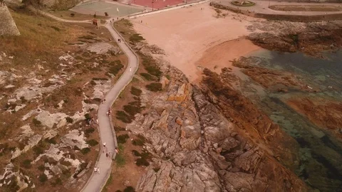 Drone flight panning over a walk path in Baiona, Galicia Stock Footage 123216974