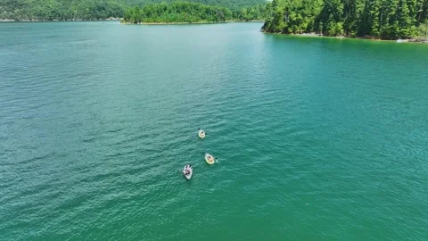 Drone flight passing over kayakers on beautiful Watauga Lake in eastern, Tn. Video stock 269774813