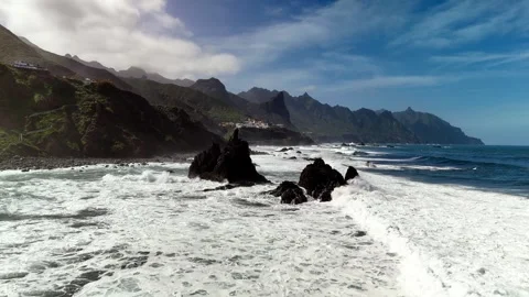 Drone flight past coastal rocks with crashing waves, Roque de las Bodegas Stock Footage 336449269