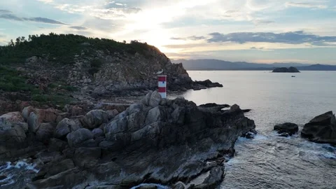 Drone flight past Ganh Den Lighthouse at sunset, Phu Yen, Vietnam Stock Footage 339406208