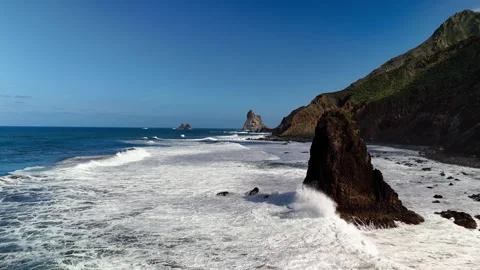 Drone flight past Roque de las Bodegas coastal rock, Tenerife Stock Footage 336448877
