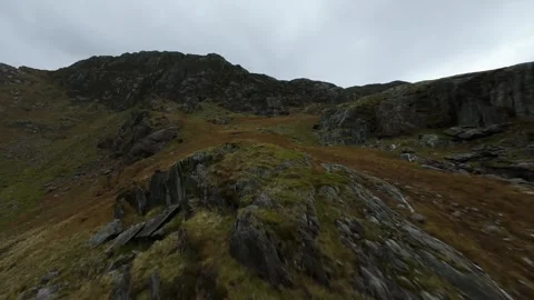 Drone flight perspective soaring over a rocky and wild mountain landscape Stock Footage 332204744