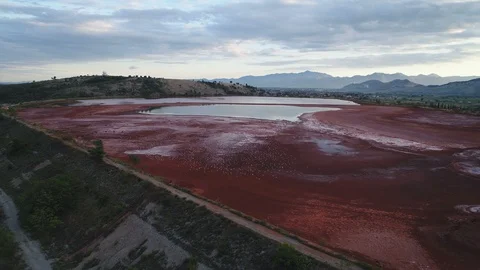 Drone flight red mud lake near old aluminum factory in Podgorica, Montenegro Stock Footage 85820752
