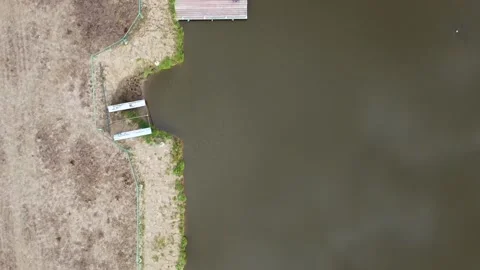 Drone flight, on the right is a small pond with a pier and a boat Video stock 152832292