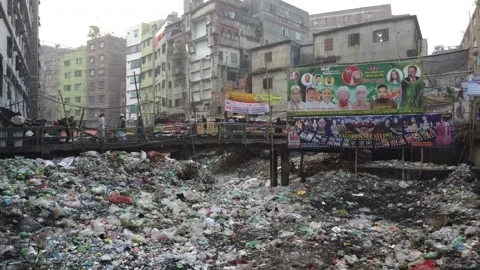 Drone Flight Rising Over Garbage Covered Urban Area with Bridge in Dhaka Video stock 327273013