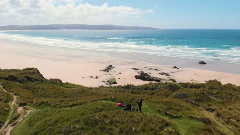 Drone flight from sea to clifftop, Gwithian beach, Cornwall, UK Stock Footage