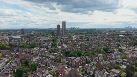 Drone flight to Selbourne Road tower blocks, Walthamstow, with London skyline Stock Footage 336413594