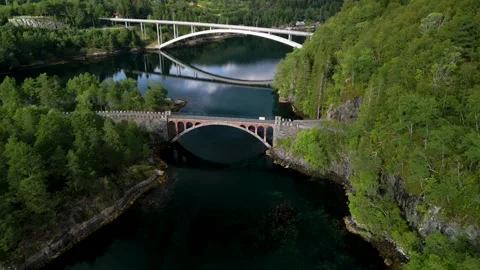 Drone flight in Straumen Norway towards stone bridge with second concrete br Stock Footage 283269300
