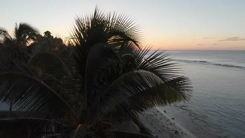 Drone flight on sunset above the ocean stripe and beach line in Cook Islands. Stock Footage 211707556