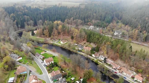 Drone flight through the clouds over the autumn forest and the river Stock Footage 145727245
