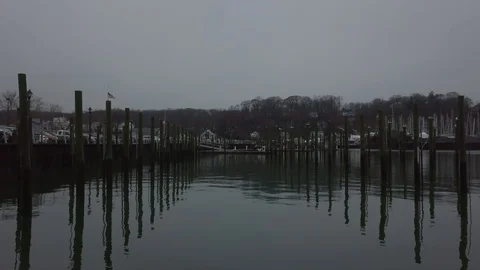Drone Flight Through Dock Pilings on Foggy Cloudy Day in Harbor Stock Footage 99307946