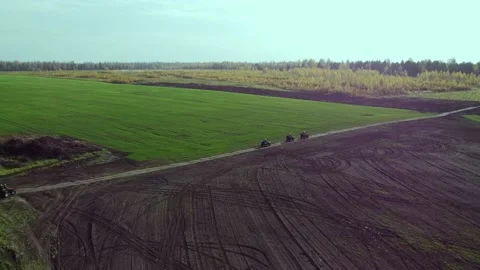 Drone flight through a field of four ATVs Stock Footage 204734565