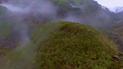 Drone flight through the fog and over a mountain. Video stock 258281156