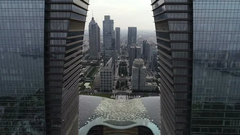 Drone flight through Gate of the East skyscraper in Suzhou, China Stock Footage 99211111