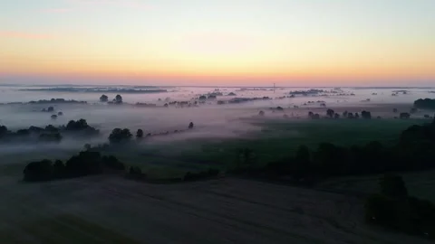 Drone flight through golden hour mist as sunrise awakens rural Sweden Stock Footage 341035917