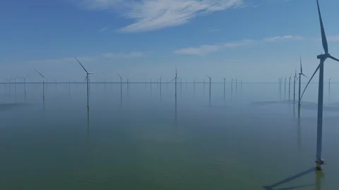 Drone flight through offshore wind farm over calm water Stock Footage 343839634
