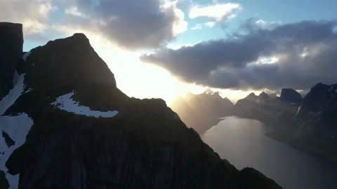 Drone flight through the snowy mountains against the backdrop of the sunset sky Stock Footage 222002431