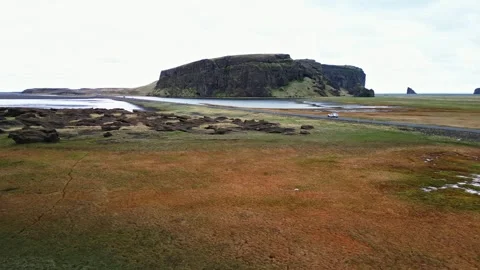 Drone flight toward flat topped sea cliff in South Iceland 4K Stock Footage 343869582
