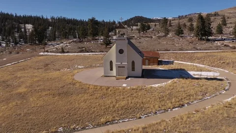 Drone flight in toward front door of white chapel on hill above Creede, CO. Stock Footage 103544908
