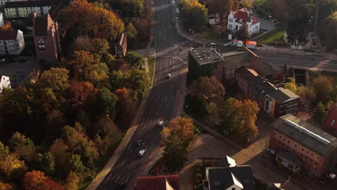 Drone flight towards a crossroad in front of the Treptower Tor of Neubrandenburg Stock Footage 239108264