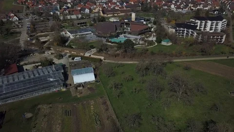 Drone flight towards the empty thermal bath in Beuren on the Swabian Alps Stock Footage 127302668