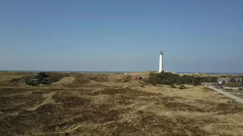 Drone flight towards Lyngvig lighthouse on Denmarks North Sea coast Stock Footage 87255077