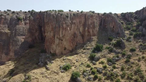Drone flight towards a massive canyon wall in an arid landscape. Stock Footage 154752012