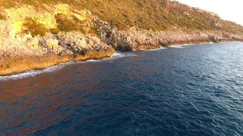 Drone flight towards sharp rocks on coastline Stock Footage 101021689