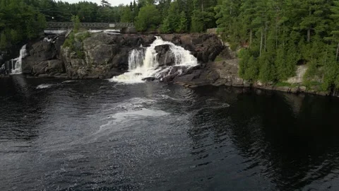 Drone Flight towards waterfall with tilt down (High Falls, Bracebridge, Musk Stock Footage 314233733