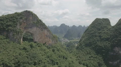 Drone flight towards Yangshuo Moon Hill and scenic mountain landscape China Stock-Footage 67534162
