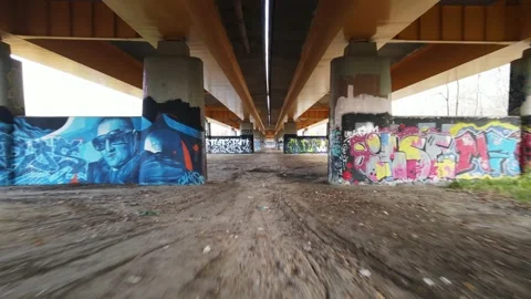 Drone flight under the bridge with graffiti pillars Stock Footage 143386346