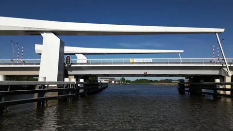 Drone flight under Gouderak bridge withe reveal of Gouda in Background Stock Footage 309097587