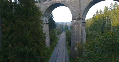 Drone flight under railway viaduct in Wisla Stock Footage 80649465
