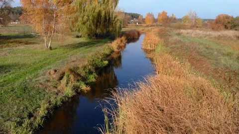 Drone flight under the tin river at the Ukrainian village at the autumn. Stock Footage 97753893