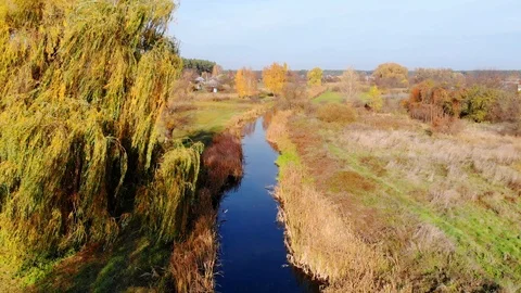 Drone flight under the tin river at the Ukrainian village at the autumn. Stock Footage 97754199