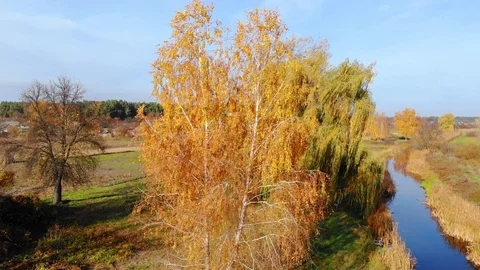Drone flight under the tin river at the Ukrainian village at the autumn. Stock Footage 97754458