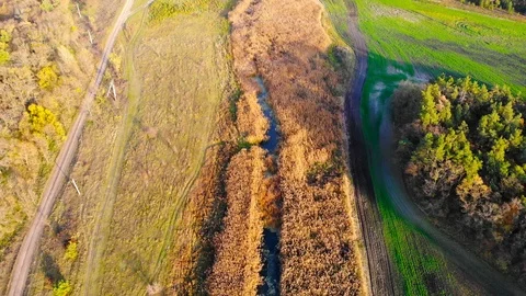 Drone flight under the tin river at the Ukrainian village at the autumn. Video stock 97756288